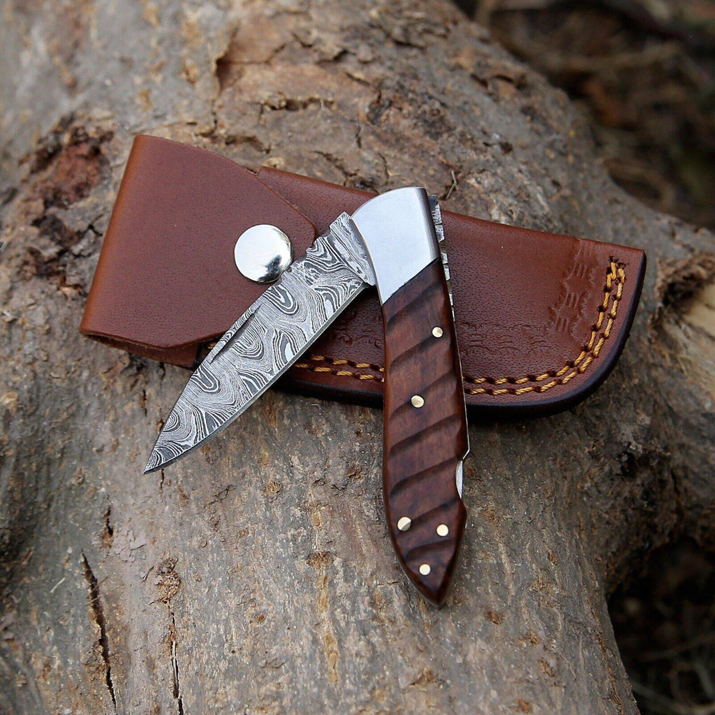 Handmade Damascus steel pocket knife with rosewood handle and steel bolster, 3-inch blade, includes leather sheath.