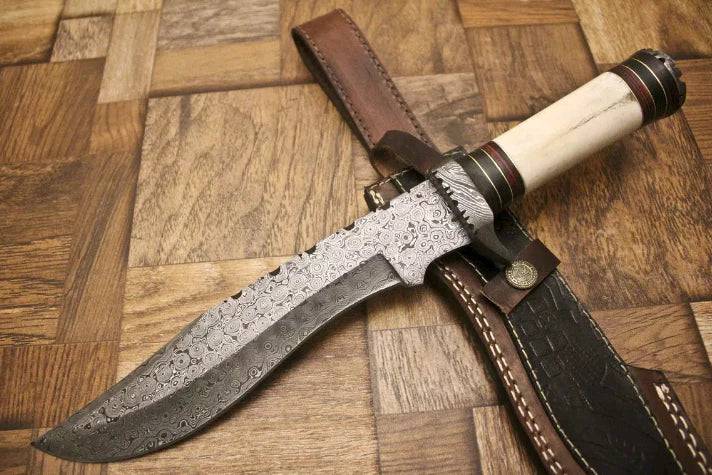 Custom handmade 13-inch Damascus steel Bowie knife with camel bone handle and Damascus guard, shown with a premium leather sheath
