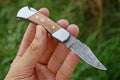 Premium handmade Damascus folding knife with a 3-inch blade, rosewood handle, and steel bolster from Knives Gear Garage.