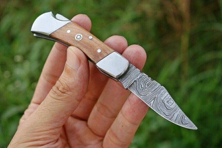 Premium handmade Damascus folding knife with a 3-inch blade, rosewood handle, and steel bolster from Knives Gear Garage.