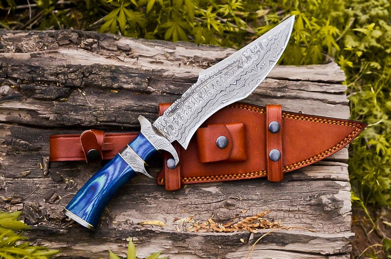 Custom handmade Damascus steel Bowie knife with Pakkawood handle, steel guard, 13-inch blade, and leather sheath.