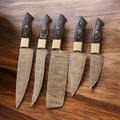 Custom kitchen knife set by Knives Gear Garage with Damascus steel blades and Pakkawood handles, ideal for holiday cooking.