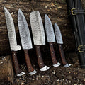 Premium handmade Damascus kitchen knives set with rosewood handles, 4 to 8-inch blades, displayed on a wooden block.