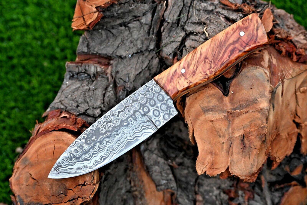 Handmade Damascus steel hunting knife with an olive wood handle and leather sheath, crafted by Knives Gear Garage.