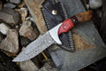 Custom handmade Damascus steel hunting knife with pakkawood and rosewood handle, steel bolster, and leather sheath.