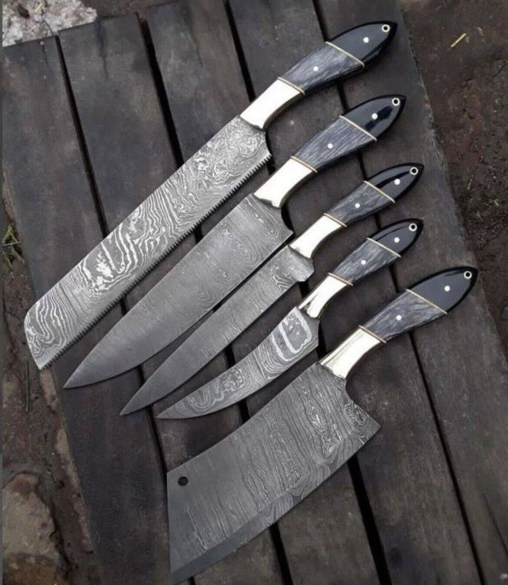 Custom handmade Damascus steel kitchen knives set with pakkawood and buffalo horn handles, leather sheath, and steel bolster.