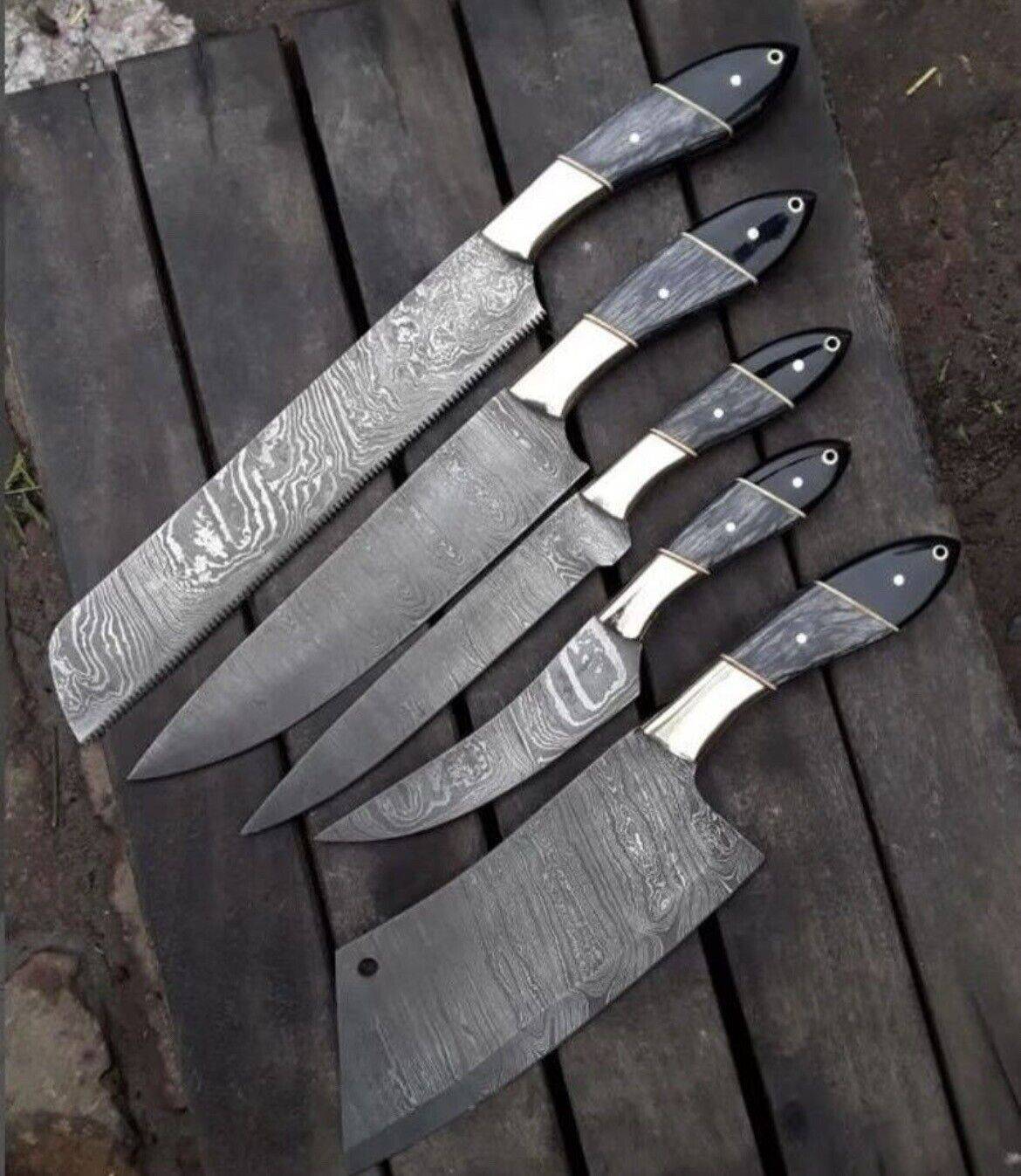 Custom handmade Damascus steel kitchen knives set with pakkawood and buffalo horn handles, leather sheath, and steel bolster.