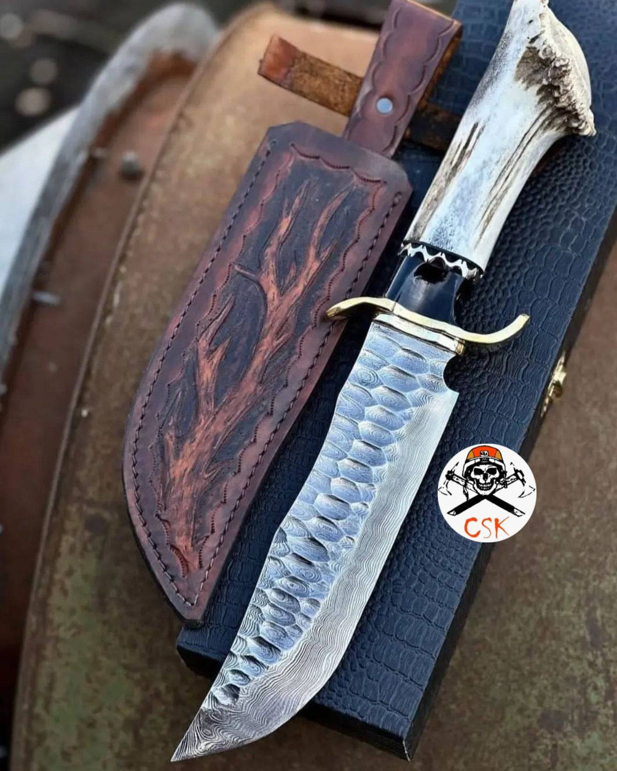 Hand-forged Damascus steel hunting knife with stag handle and custom leather sheath by cskforged, ideal for outdoor hunting.