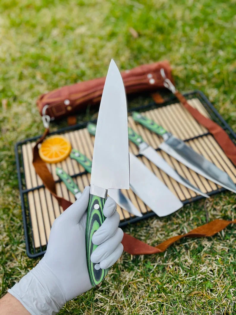 Custom handmade J2 Steel kitchen knife set by Knives Gear Garage, featuring G10 handles, steel bolsters, and a leather roll kit.