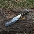 Damascus gut hook skinning knife with stag horn handle by Malika Knives, featuring a sharp curved blade for field dressing game.