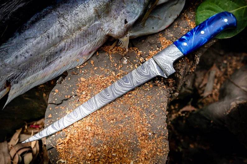 Detailed view of a 13-inch Damascus fillet knife with a blue resin handle and Damascus steel bolster from Knives Gear Garage.