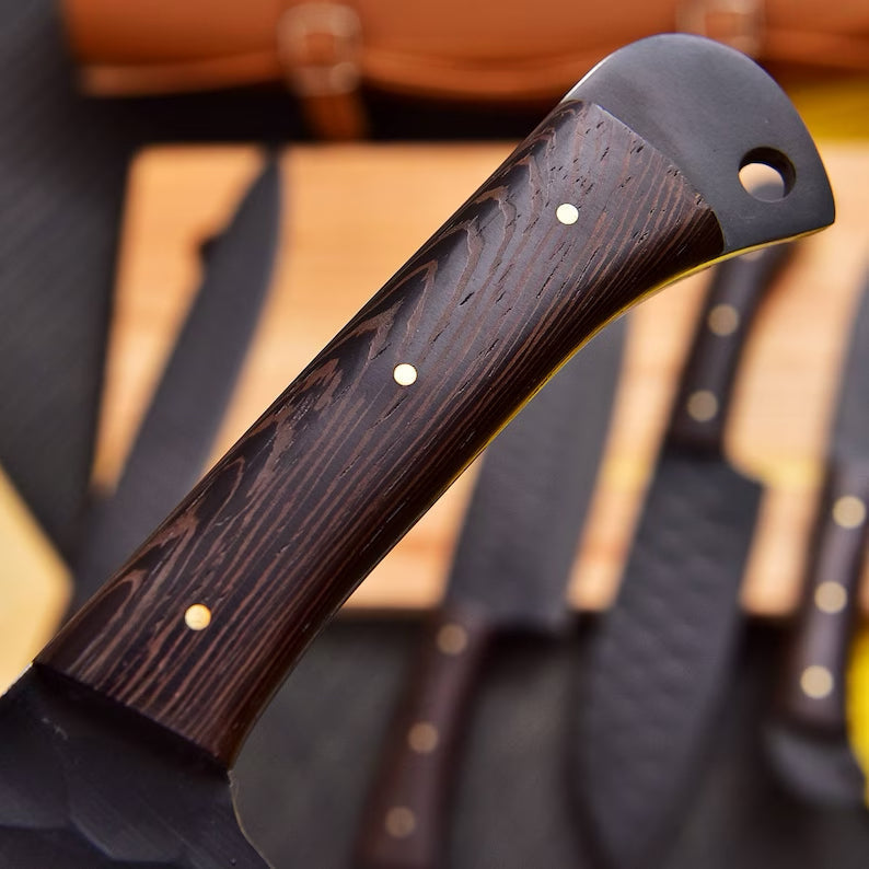 Set of stainless steel kitchen knives from Knives Gear Garage with black handles, displayed on a wooden cutting board.