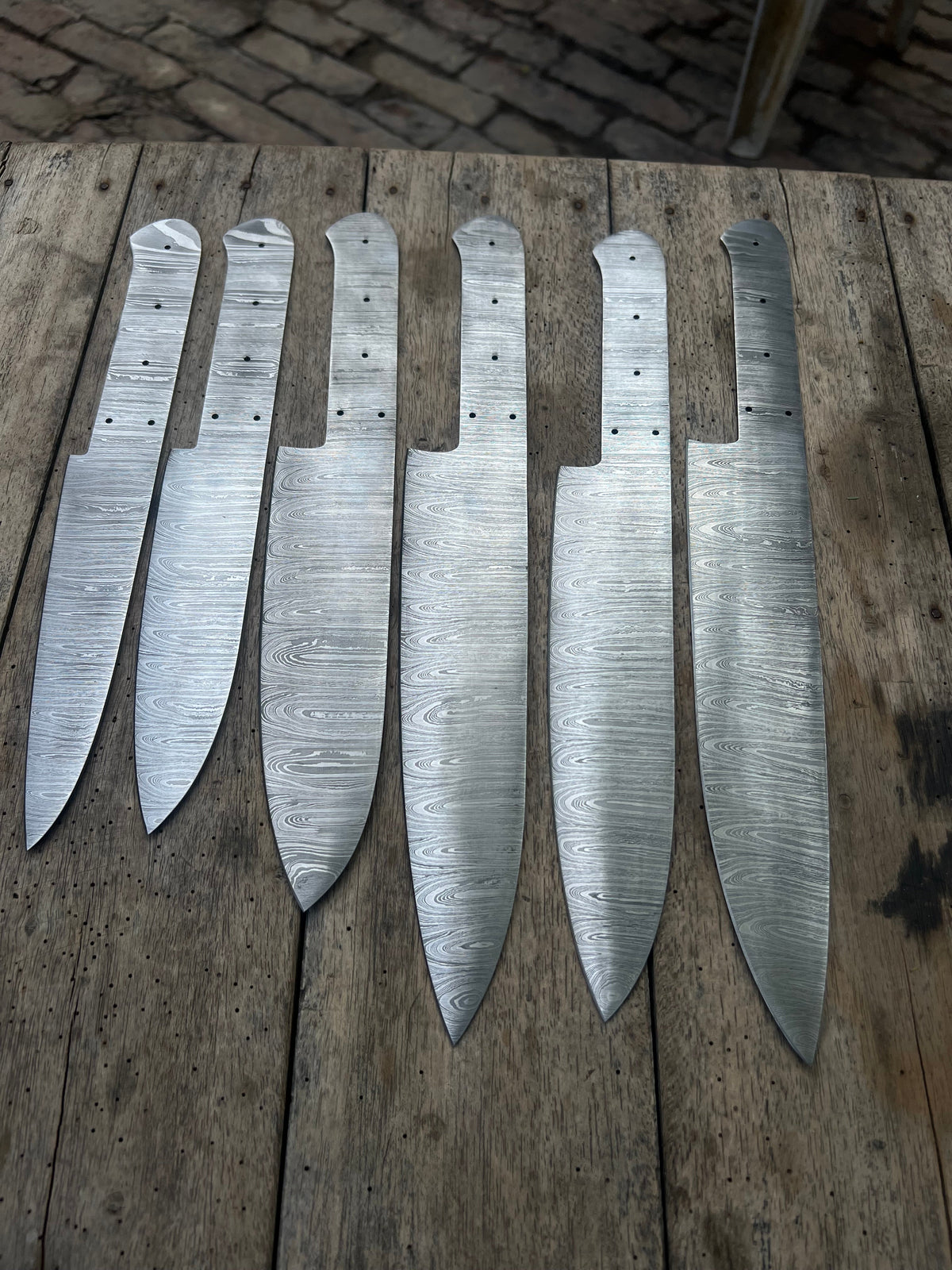 Six handmade Damascus chef knives with forged steel blades from JW SteelCrafts, ideal for custom knife making projects.