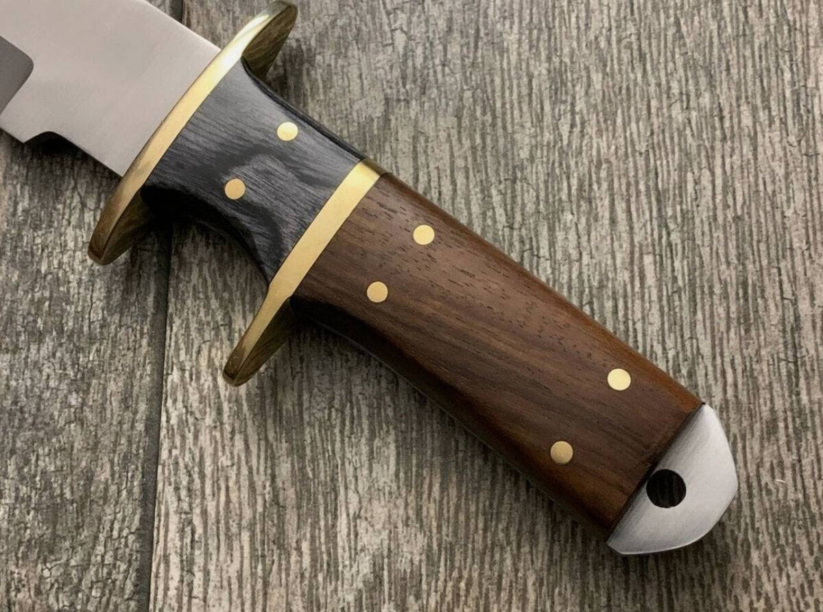 Handmade cskforged knife with brass guard and rosewood handle, showcasing detailed craftsmanship and polished wood grain.