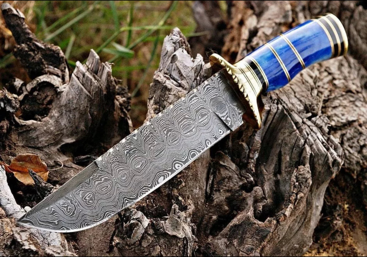 Handmade Damascus steel Bowie knife with brass guard, color bone handle, leather sheath, crafted by Knives Gear Garage.