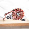 Handmade red, black, and orange leather bullwhip by Knives Gear Garage, 4ft to 16ft length with detailed leather craftsmanship.