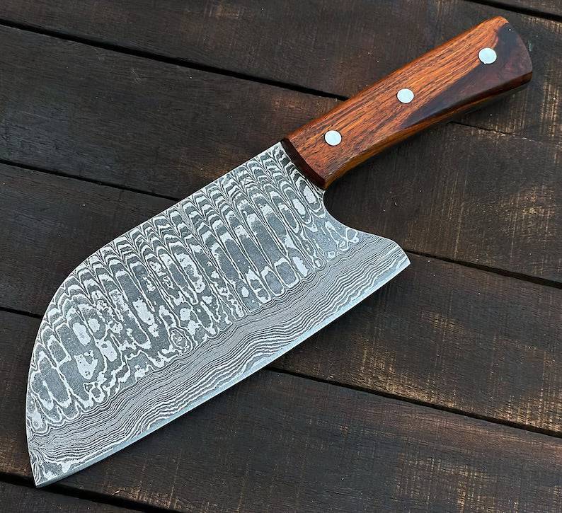 Handmade 10-inch Damascus steel cleaver knife with rosewood handle and leather sheath, featuring a sturdy and sharp blade.