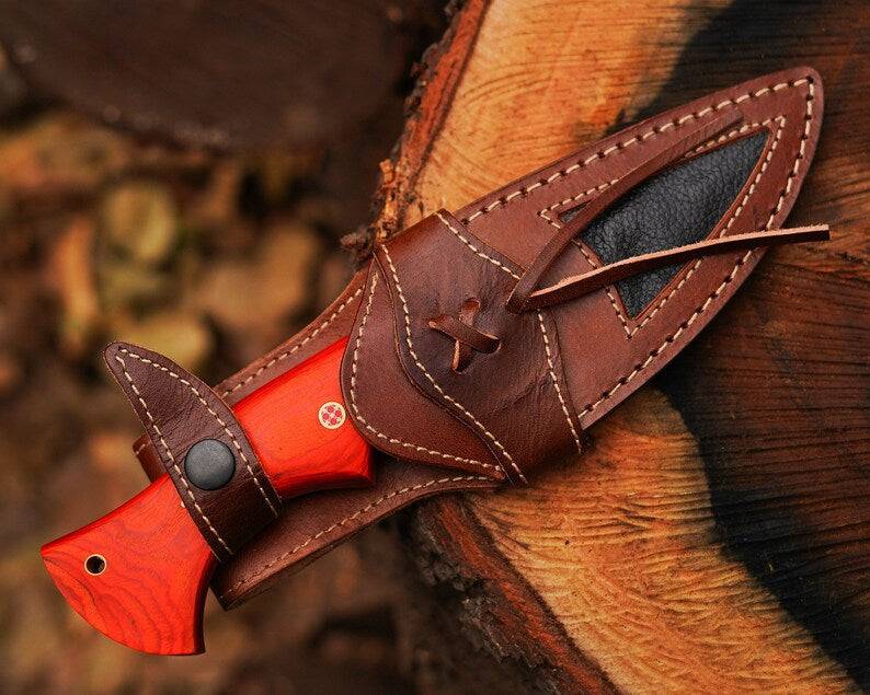 Damascus steel hunting knife by cskforged with a textured handle and sharp blade, ideal for outdoor hunting and survival activities.