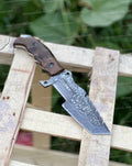 Custom handmade Damascus steel tracker knife with a textured handle, crafted by Knives Gear Garage.