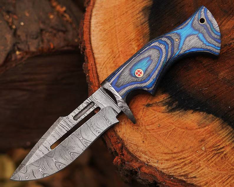 Damascus steel hunting knife by cskforged with a textured handle and sharp blade, designed for outdoor hunting and survival tasks.