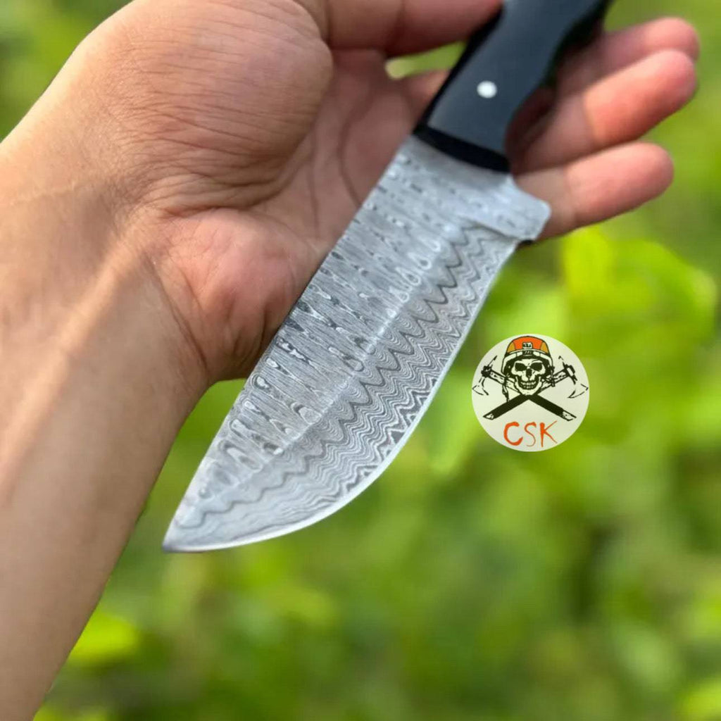 Premium hand-forged Damascus steel hunting knife with ergonomic black handle from cskforged, high-performance blade for outdoor use.