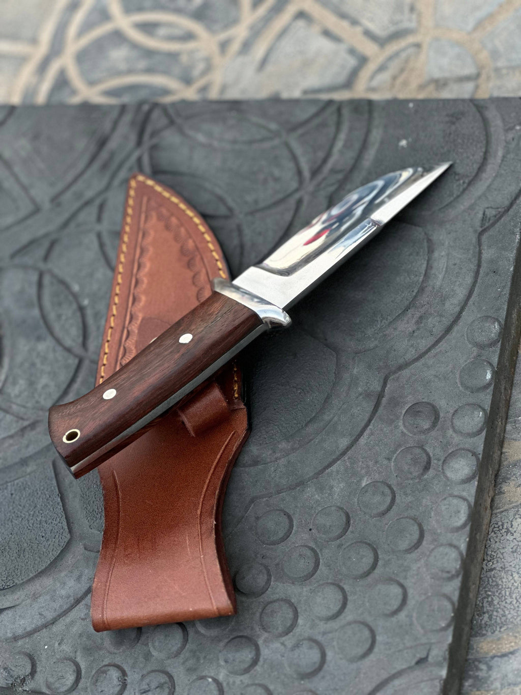 Handmade 1095 steel hunting knife with wooden handle by Knives Gear Garage, showcasing its sharp blade and craftsmanship.