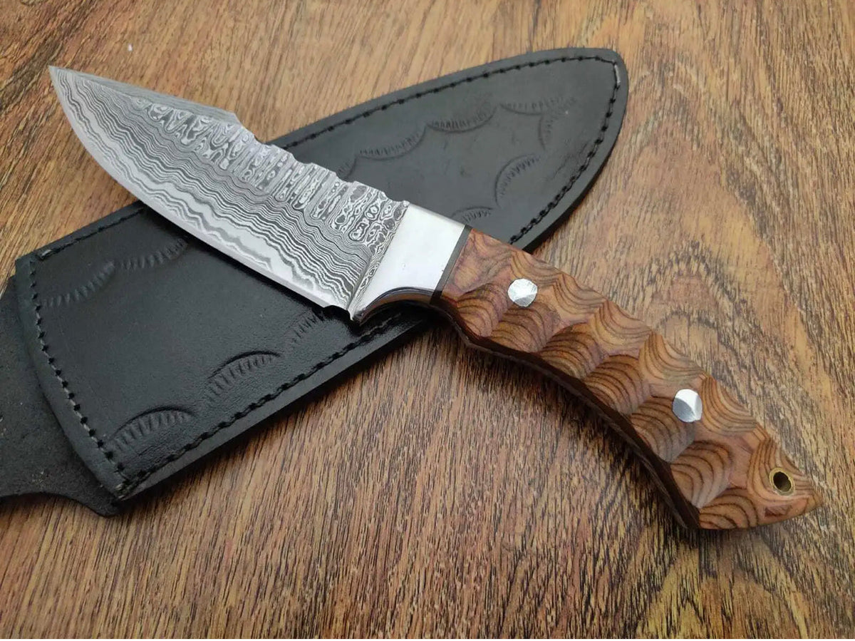 Custom handmade Damascus steel bushcraft hunting knife with ergonomic handle and sharp blade, ideal for camping and outdoor survival.