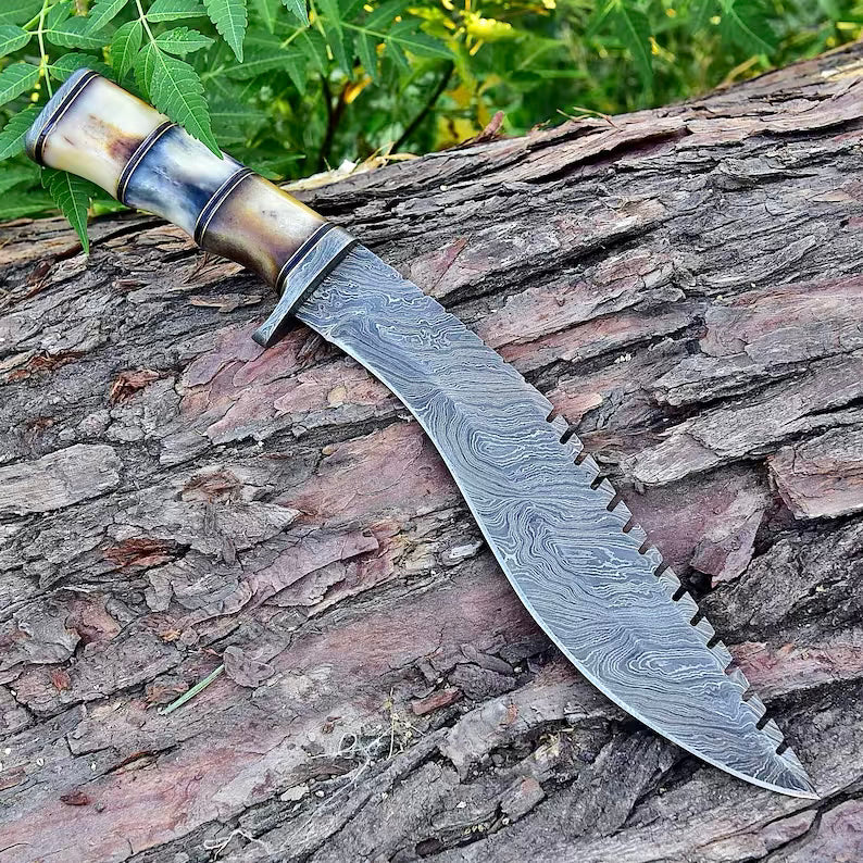 Damascus Steel Kukri Knife from Knives Gear Garage with a curved blade and wooden handle, displayed on a dark background.