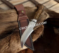 Handmade eagle head hunting knife by cskforged with a detailed eagle design on the blade and a sturdy handle.