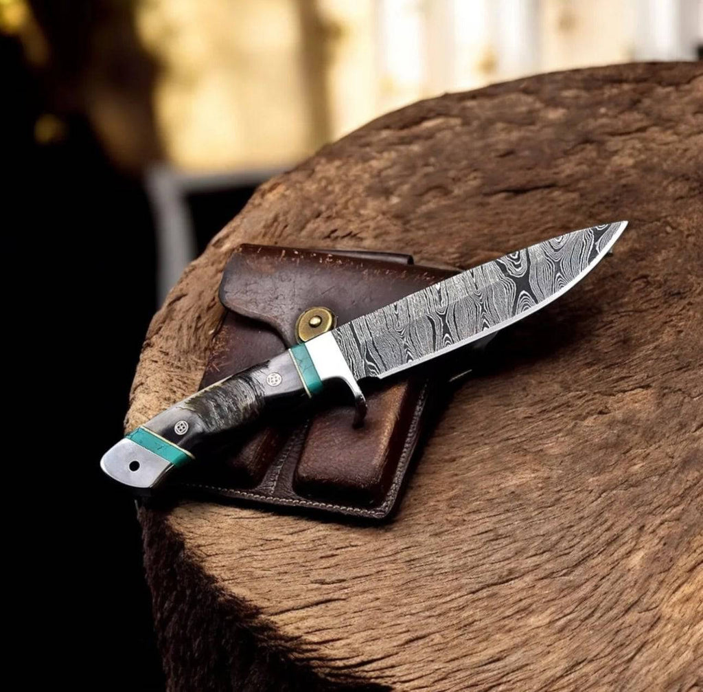 Handmade Damascus sheep hunting knife by cskforged with a detailed, patterned blade and a sturdy handle for outdoor hunting.