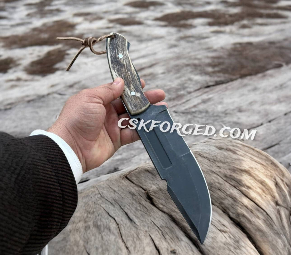 CSKforged D2 Steel hunting and survival knife with antler handle, full view showing sharp blade and textured grip.