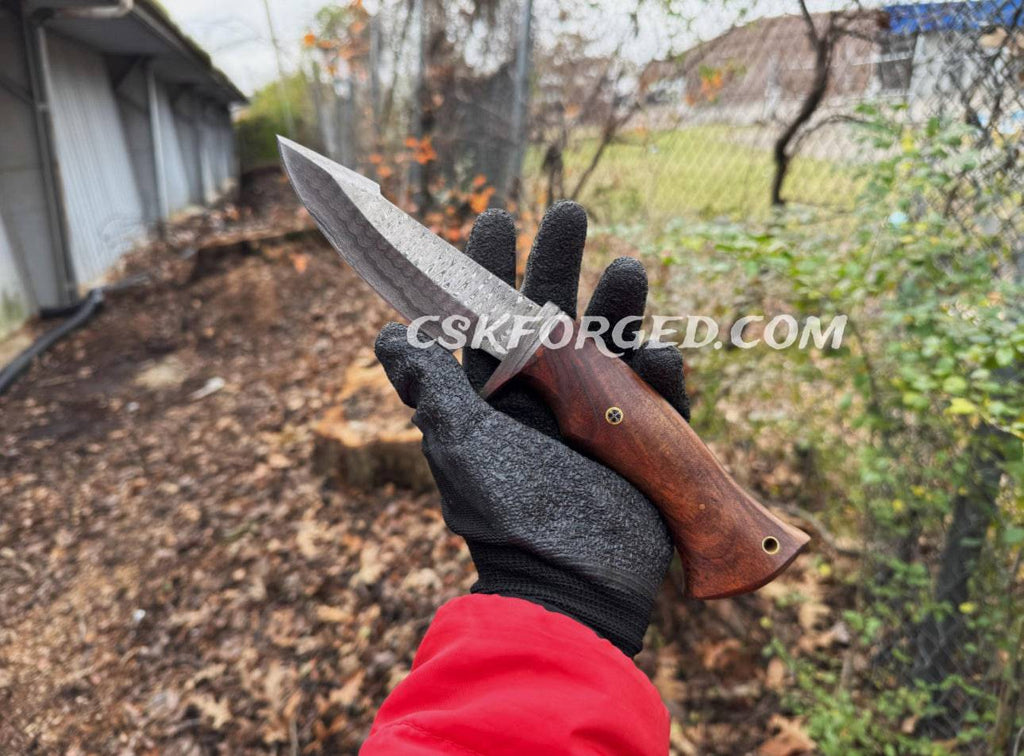 Damascus steel hunting knife with rose wood handle by cskforged, featuring a sharp blade and polished wooden grip.