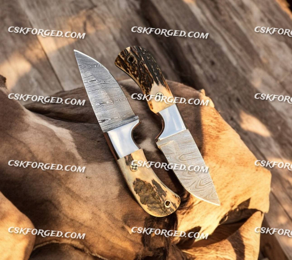 Frontier Ranger custom Old West hunting knives set by cskforged, featuring leather sheaths and polished blades on a wooden background.