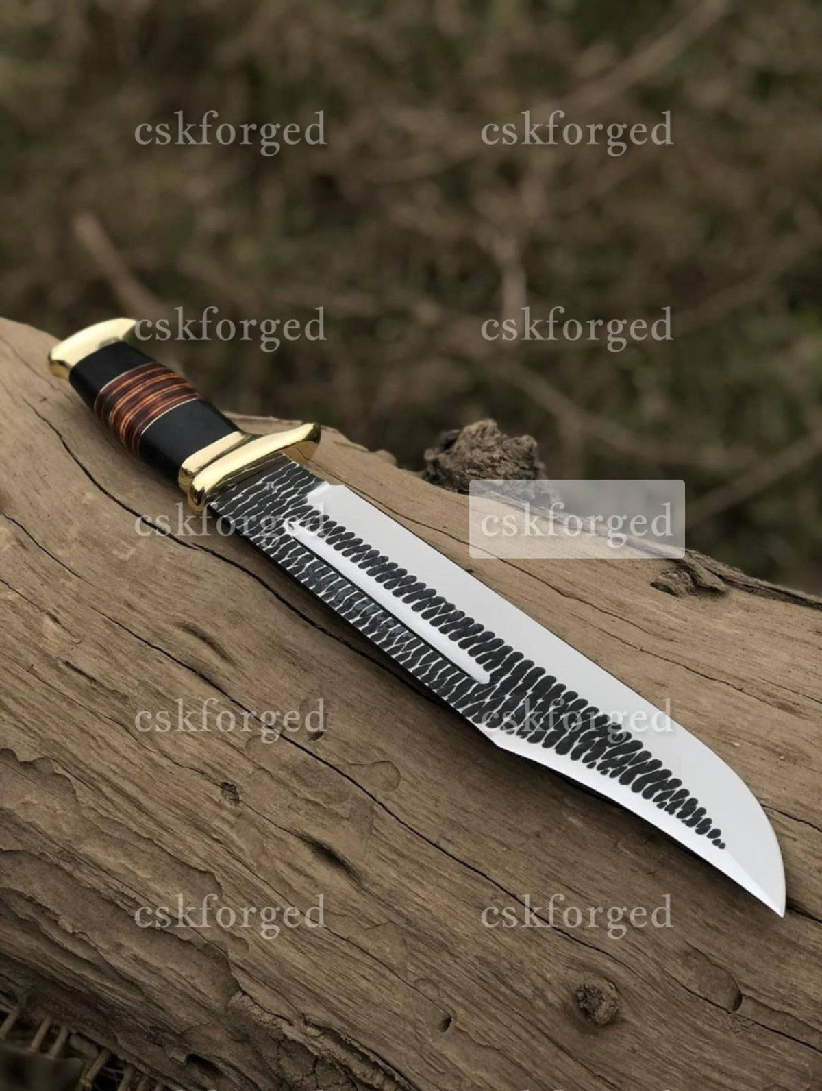 Custom handmade Dundee knife by cskforged featuring a detailed crocodile Dundee-inspired design and a sturdy blade.