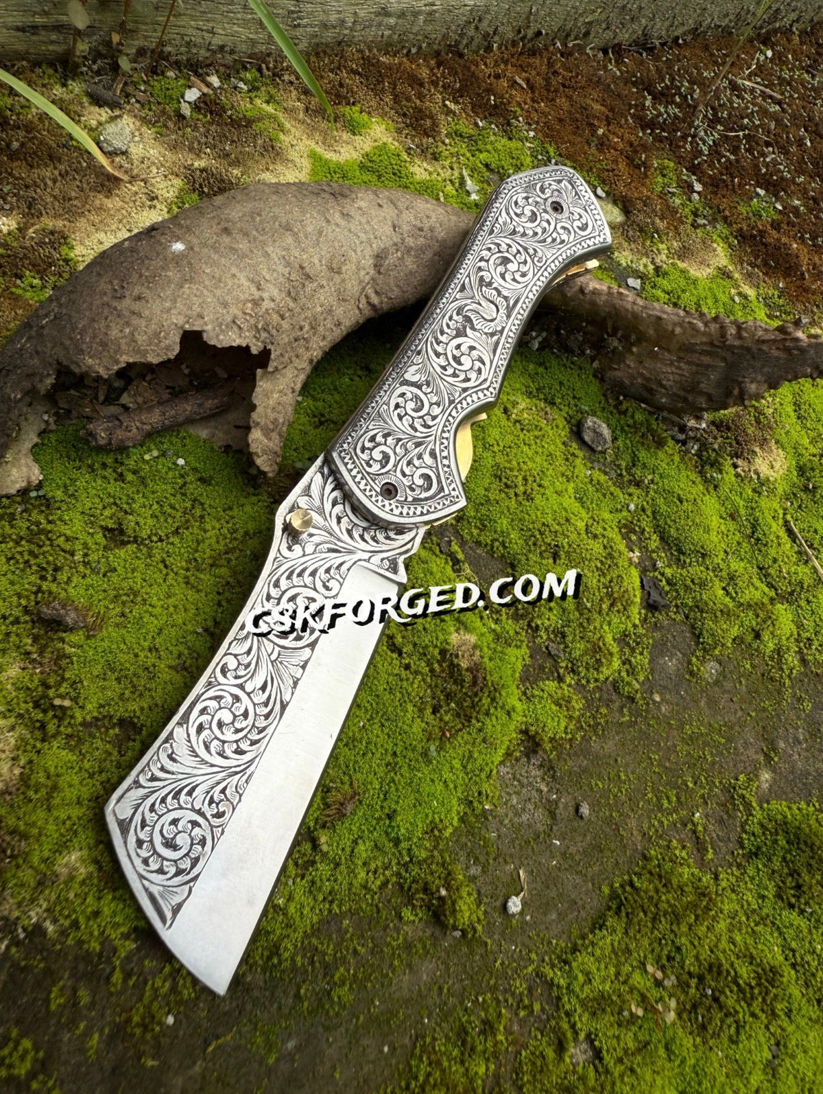 Hand-engraved scrollwork pocket knife by cskforged with detailed metalwork and a classic folding blade.