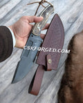 D2 steel hunting and survival knife with antler handle, featuring a full tang blade and textured grip for outdoor use.