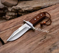 CSKforged Loveless Style D2 Steel Hunting Knife with brown Micarta handle and leather sheath, full view of the knife's blade and handle.