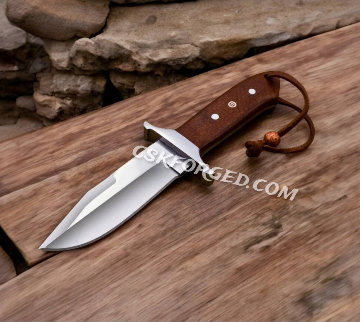 CSKforged Loveless Style D2 Steel Hunting Knife with brown Micarta handle and leather sheath, full view of the knife's blade and handle.