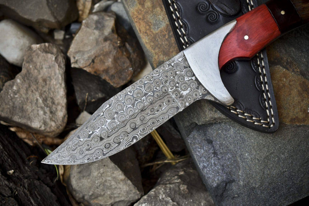 Handcrafted Damascus steel hunting knife with pakkawood and rosewood handle, steel bolster, and leather sheath.