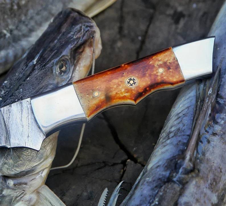 Handmade 13-inch Damascus steel fillet knife with camel bone handle and leather sheath, crafted by Knives Gear Garage.
