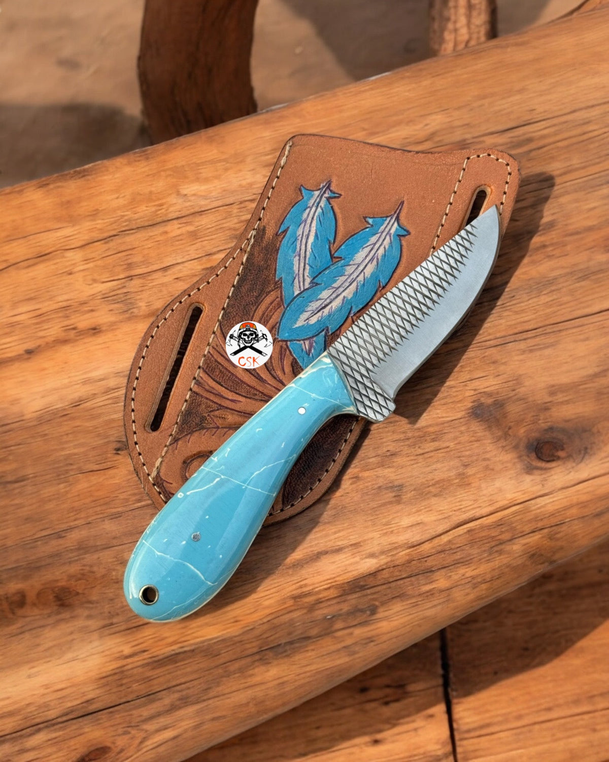 CSK Forged Saloon Savior Western EDC knife with rasp steel blade and epoxy resin inlay, shown in a close-up image.