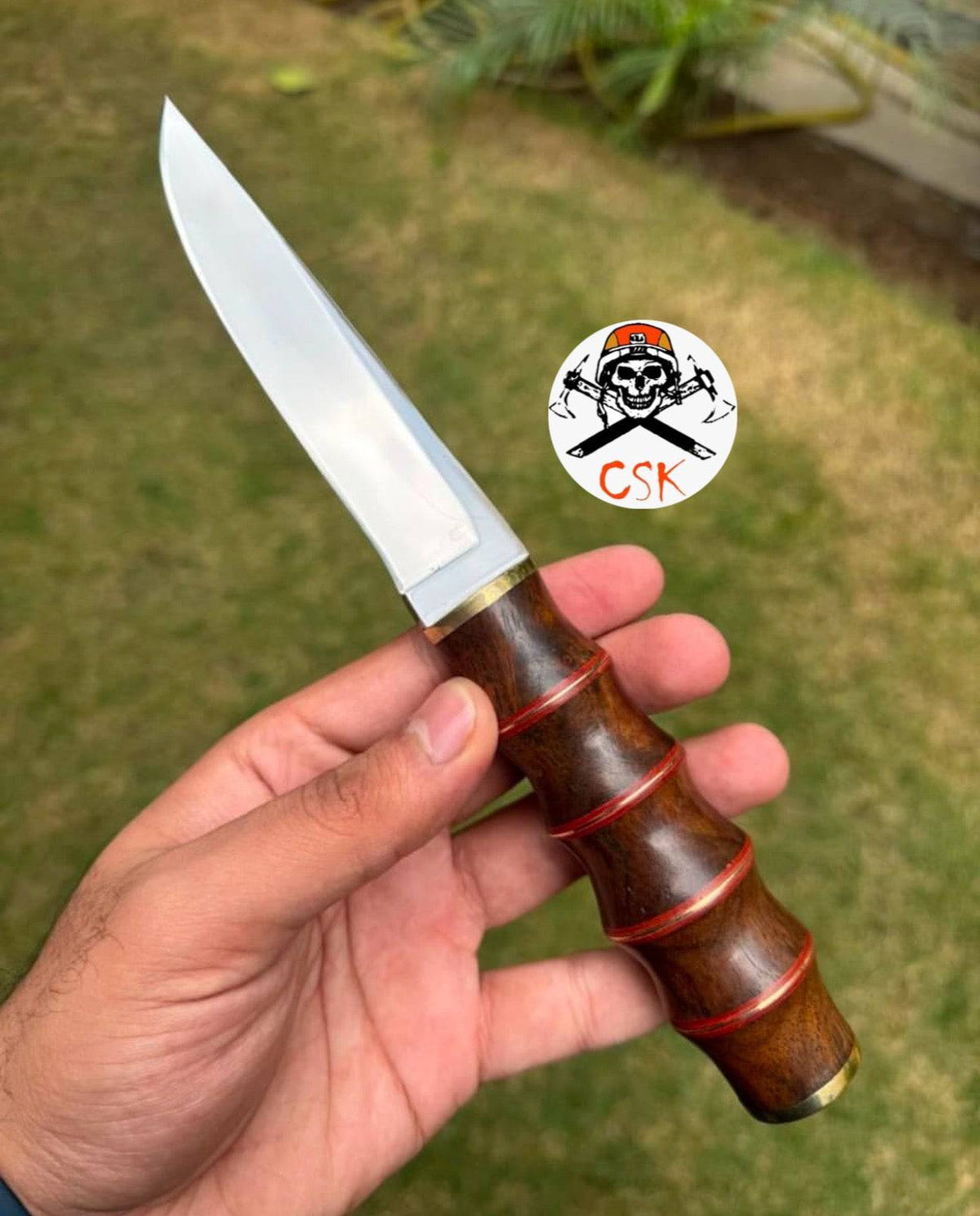 Handmade D2 tool steel pukko hunting knife with a wooden handle, ideal for meat cutting and outdoor use.