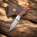 Damascus folding pocket knife with a Pakka wood handle, leather sheath, crafted by cskforged.