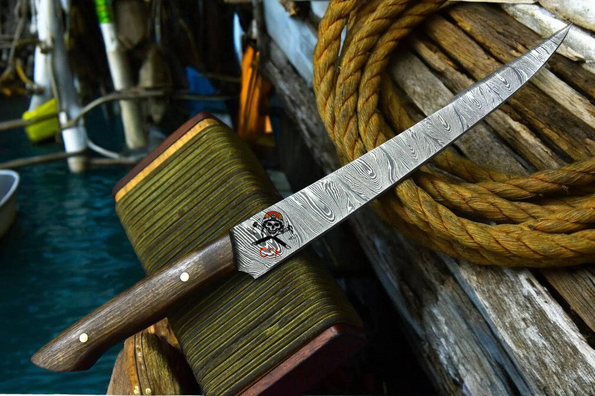 Handmade personalized Damascus fillet knife with rosewood handle by cskforged, featuring a sharp, curved fish filleting blade.