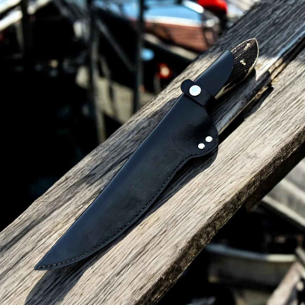 Handmade Damascus steel fillet knife with an antler handle from cskforged, featuring a sharp slim blade ideal for fish filleting.