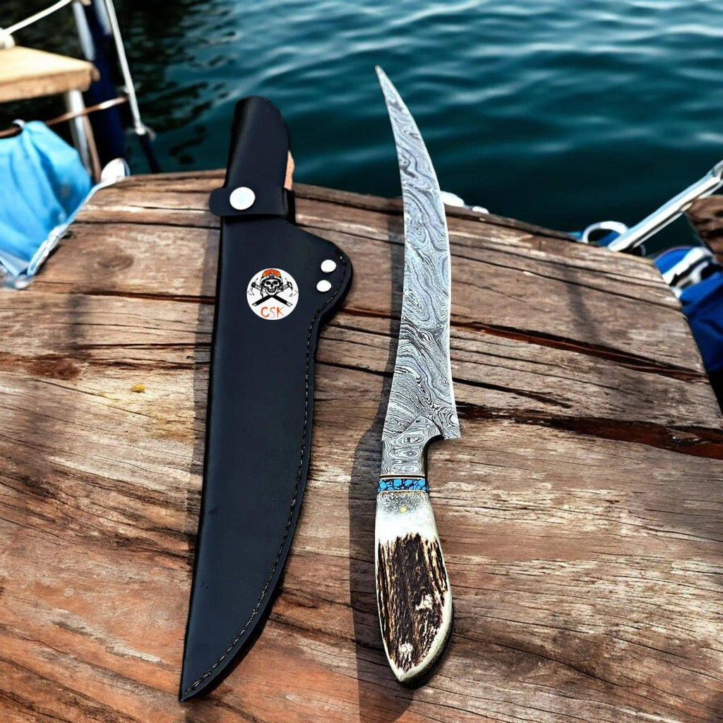Handmade Damascus steel fillet knife with antler handle by cskforged, featuring a sharp, curved blade ideal for fish filleting.
