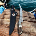 Handmade Damascus steel fillet knife with antler handle by cskforged, featuring a sharp, curved blade ideal for fish filleting.