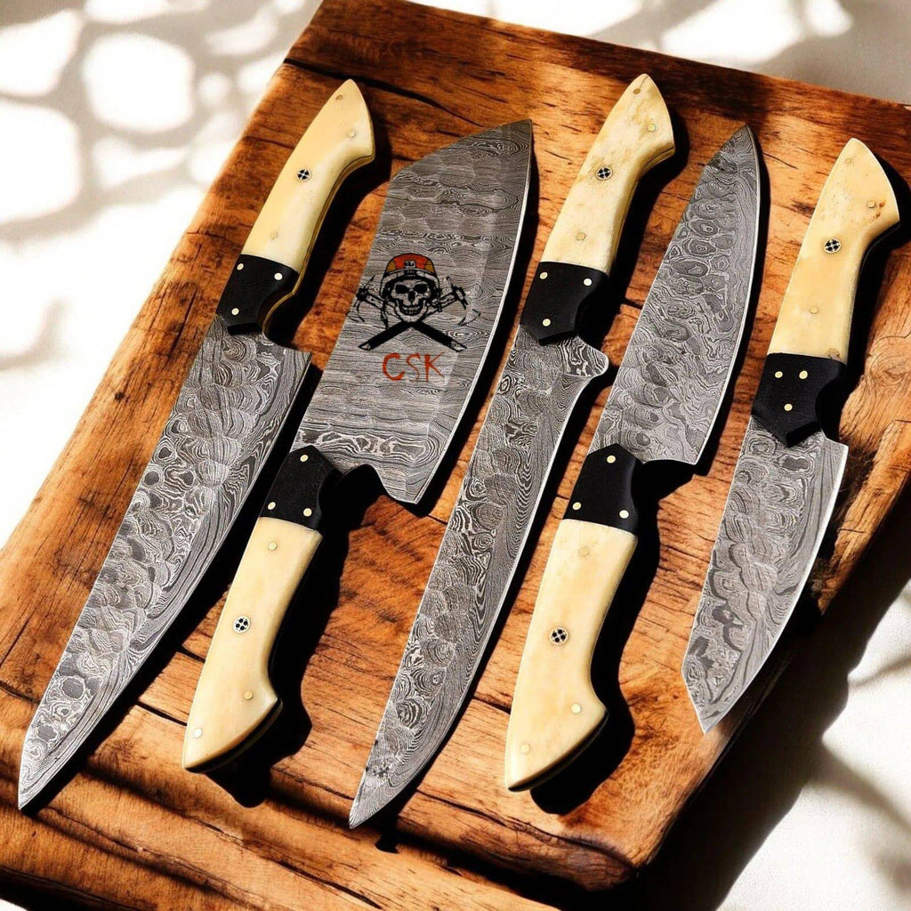 Handmade premium Damascus kitchen knife set with five knives featuring bone handles, crafted by cskforged.