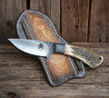 Heritage Working Cowboy Knife with antler handle and 1095 steel blade, shown with back belt sheath, by cskforged.