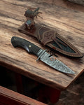 Handcrafted Bobcat hunting knife with 9.25-inch Damascus steel blade and Wengewood handle, ideal for outdoor and collector use.